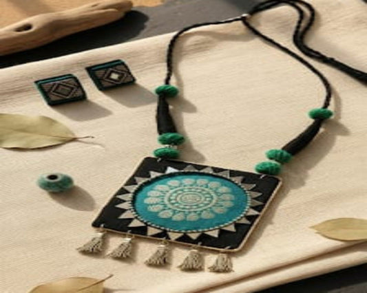 Necklace with decorative pendant on a textured surface