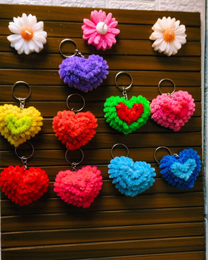 Colorful heart and flower keychains on a wooden surface
