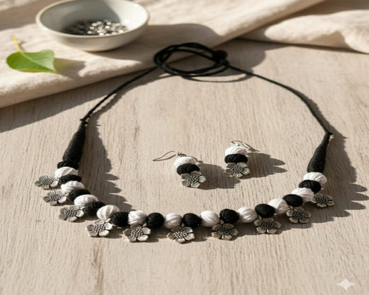 Jewelry set with necklace and earrings on a wooden surface
