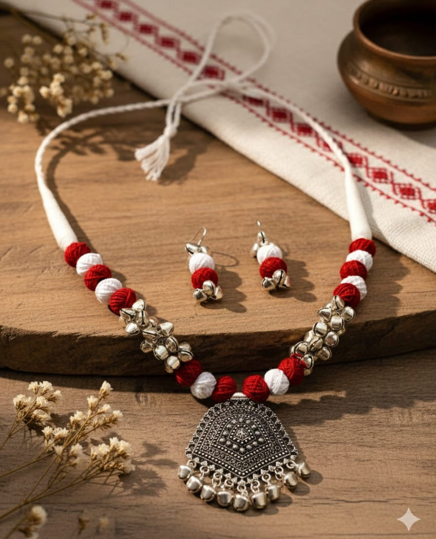 Jewelry set with necklace and earrings on a wooden surface