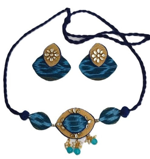 Blue and gold necklace with matching earrings on a white background