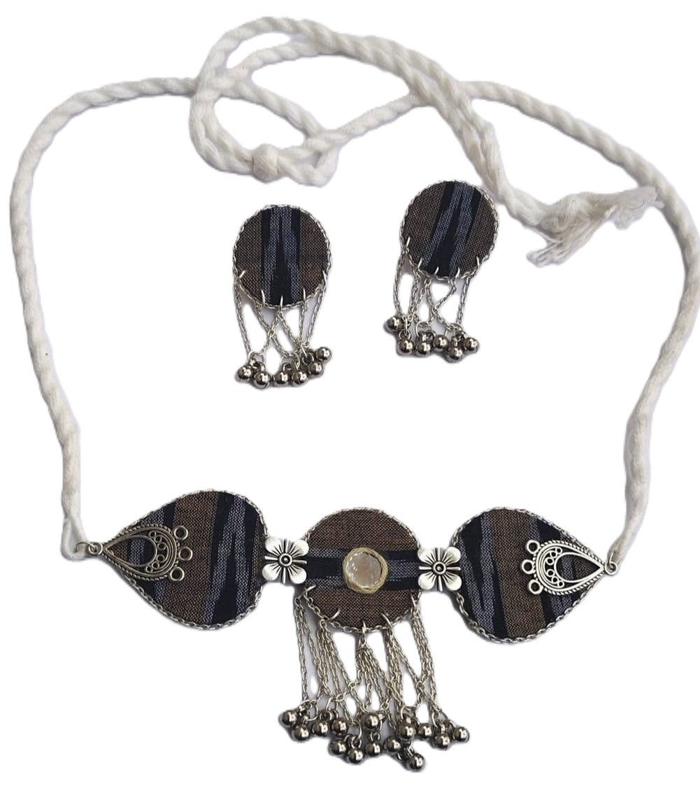 Necklace and earrings set with black and silver design on a white background