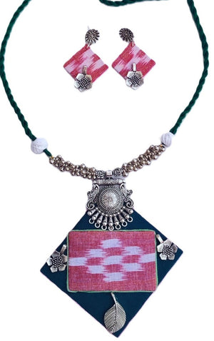 Necklace with geometric pendant and matching earrings on a white background