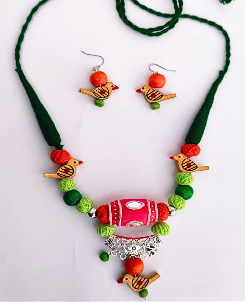 Colorful necklace with bird-shaped pendants on a white background