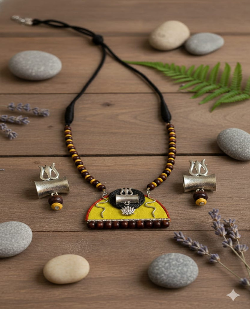 Necklace with wooden beads and a decorative DAMRU pendant on a white background
