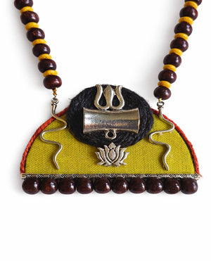 Necklace with wooden beads and a decorative DAMRU pendant on a white background