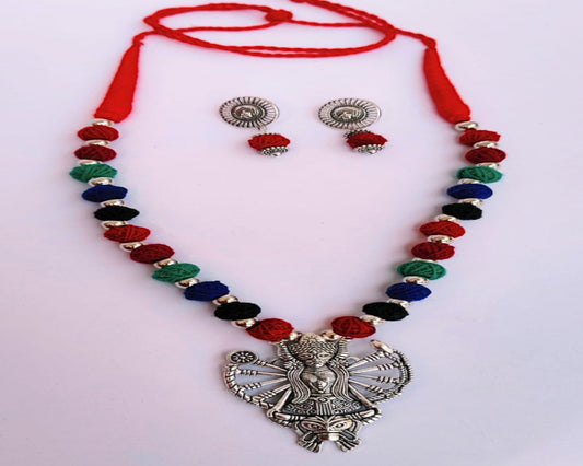 Colorful beaded necklace with a large silver pendant and matching earrings.