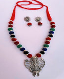 Colorful beaded necklace with a large silver pendant and matching earrings.