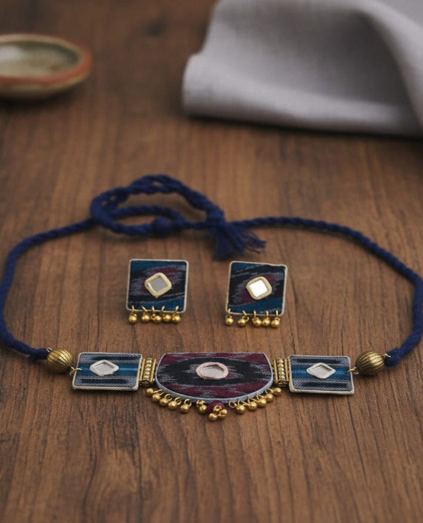 Necklace with blue cord and decorative elements on a wooden surface